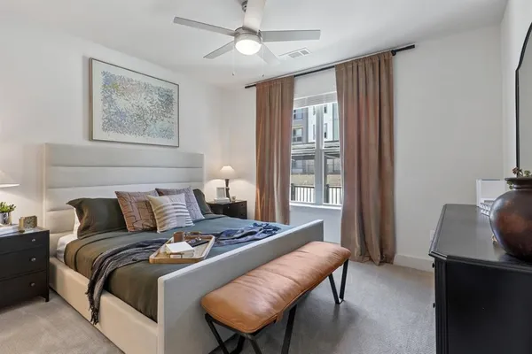 a bedroom with a bed and a window