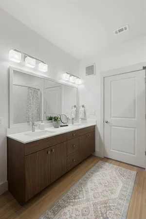 a spacious bathroom with a granite countertop sink mirror and