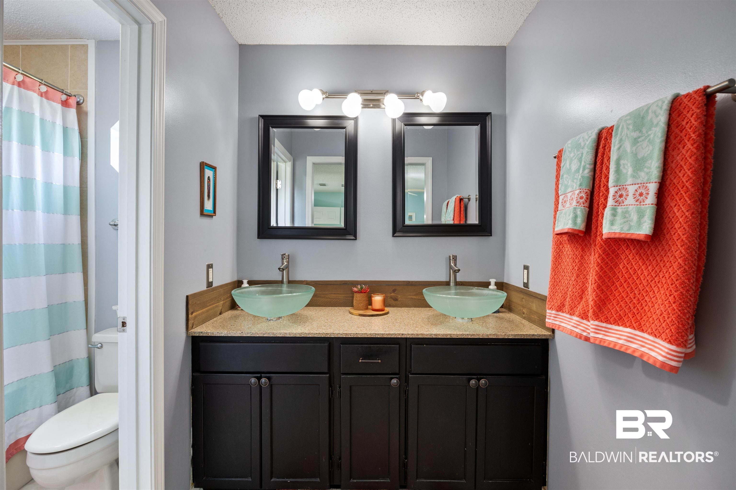 9771 Clarke Ridge Road Foley, AL 36535 - Photo 54 of 72 Bathroom with a sink, double vanity, a textured ceiling, and toilet.
