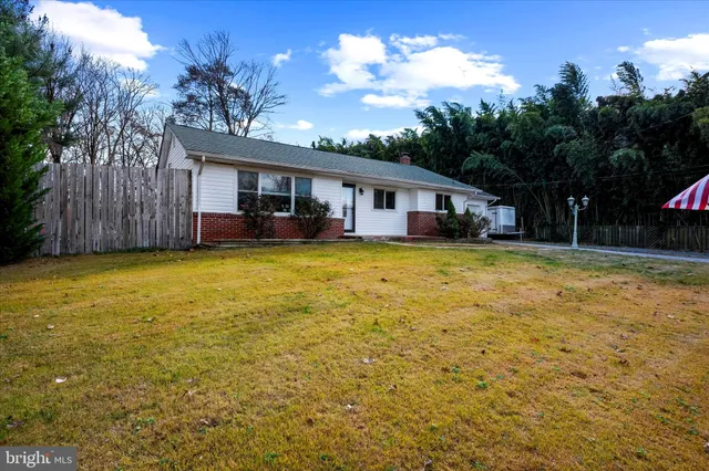 a view of a house with swimming pool and a yard