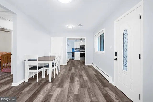 a view of a house with dining room and wooden floor
