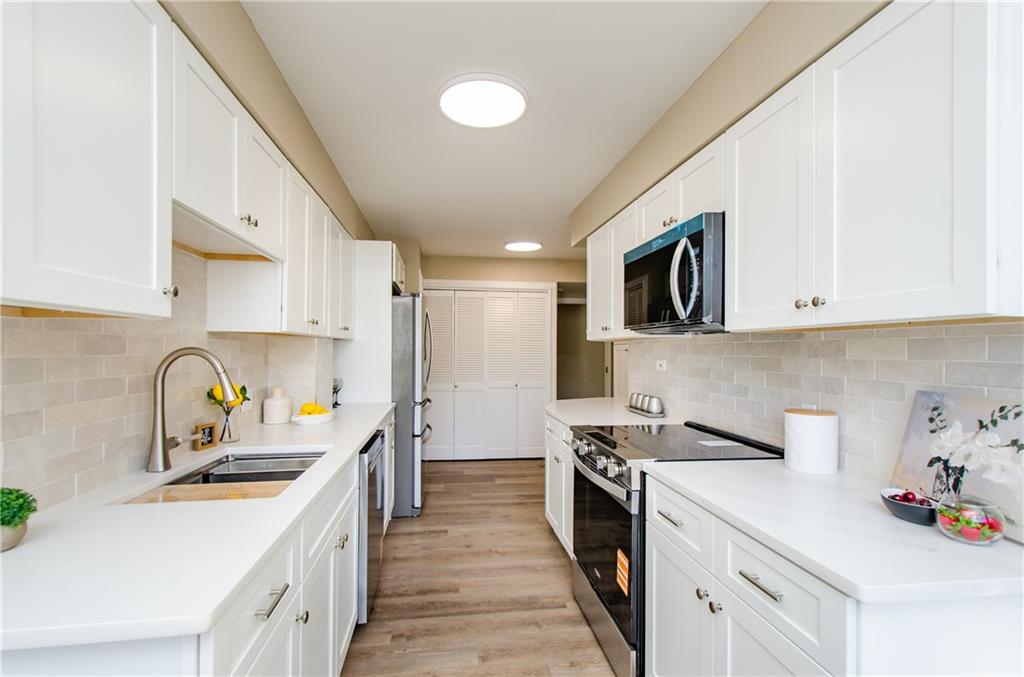 3530 Piedmont Road Northeast, Unit F5 Atlanta, GA 30305 - Photo 11 of 28 a kitchen with a sink a stove and cabinets