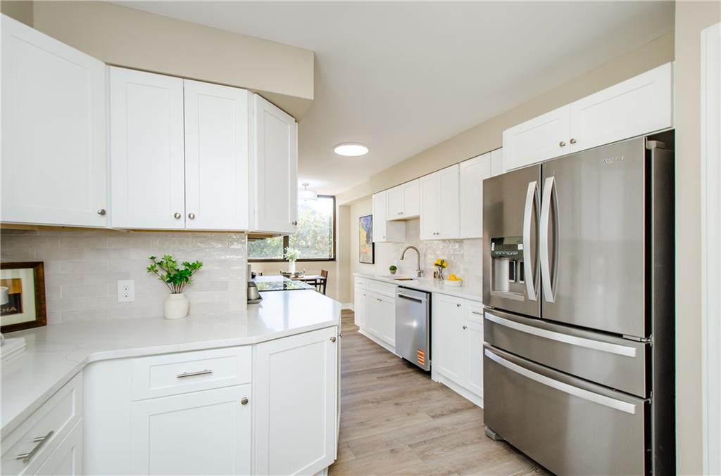 3530 Piedmont Road Northeast, Unit F5 Atlanta, GA 30305 - Photo 15 of 28 a kitchen with white cabinets and stainless steel appliances