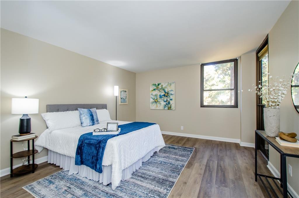 3530 Piedmont Road Northeast, Unit F5 Atlanta, GA 30305 - Photo 16 of 28 a bedroom with a large bed and a window