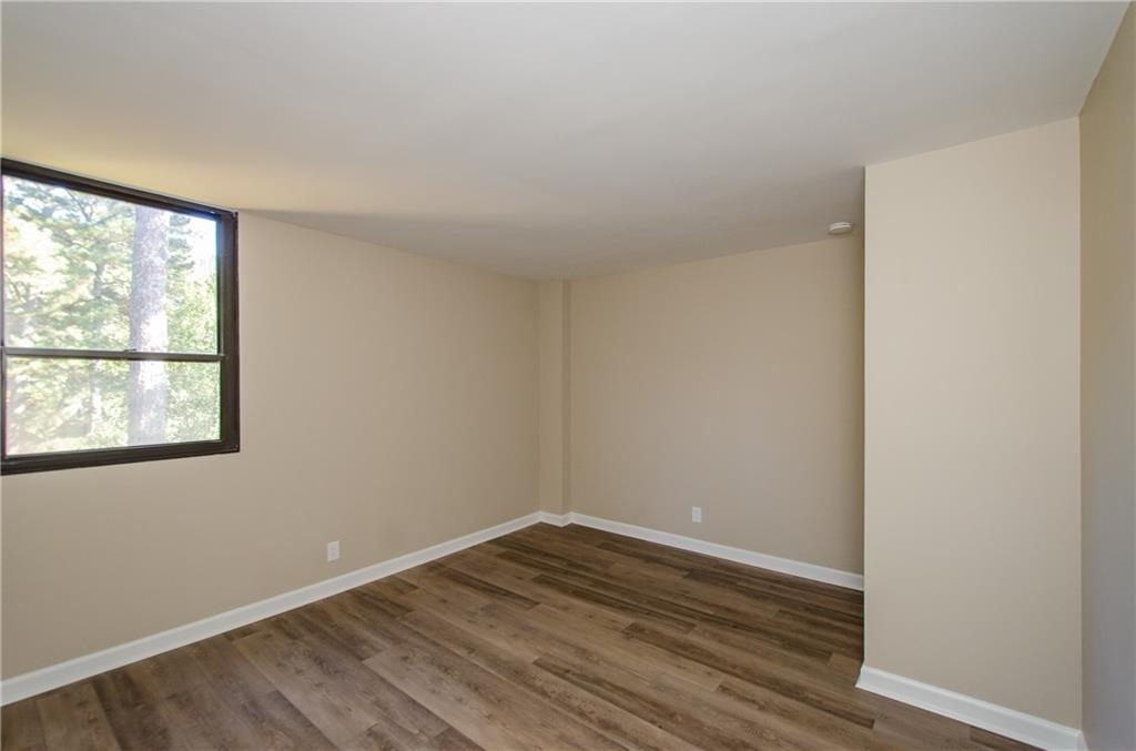 3530 Piedmont Road Northeast, Unit F5 Atlanta, GA 30305 - Photo 22 of 28 an empty room with wooden floor and windows