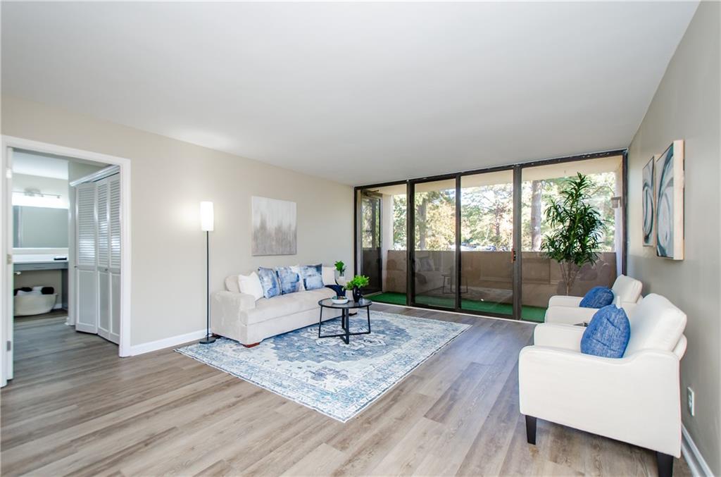 3530 Piedmont Road Northeast, Unit F5 Atlanta, GA 30305 - Photo 5 of 28 a living room with furniture and a large window