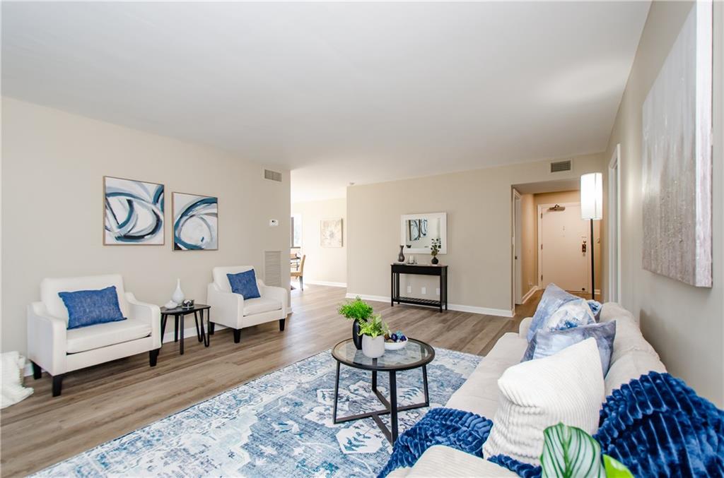 3530 Piedmont Road Northeast, Unit F5 Atlanta, GA 30305 - Photo 6 of 28 a living room with furniture and wooden floor