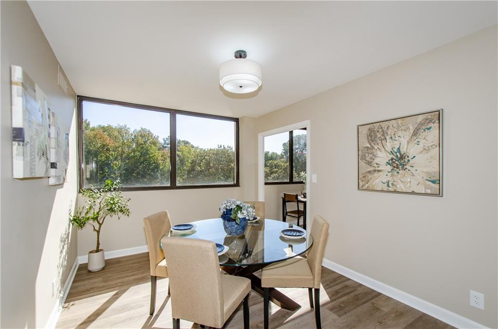 3530 Piedmont Road Northeast, Unit F5 Atlanta, GA 30305 - Photo 7 of 28 a view of a dining room with furniture window and outside view