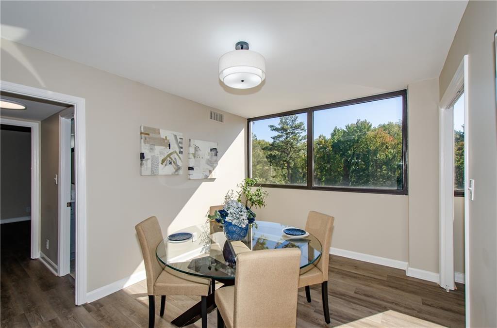 3530 Piedmont Road Northeast, Unit F5 Atlanta, GA 30305 - Photo 8 of 28 a dining room with furniture and window