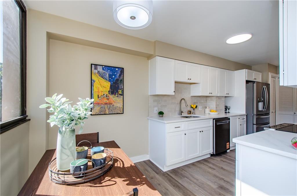 3530 Piedmont Road Northeast, Unit F5 Atlanta, GA 30305 - Photo 9 of 28 a kitchen with a white stove top oven and white cabinets