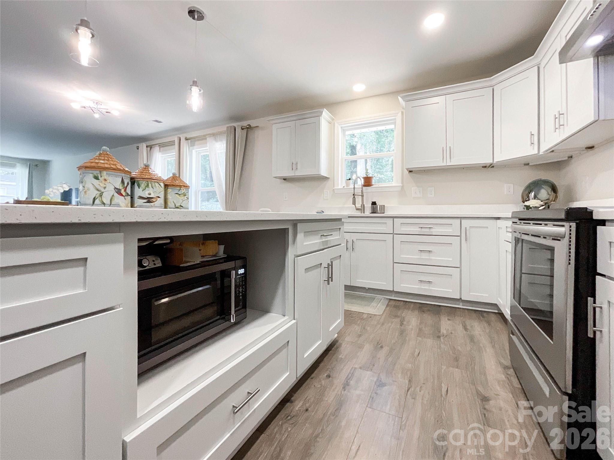 404 White Store Road Wadesboro, NC 28170 - Photo 12 of 38 a kitchen with wooden floors and appliances