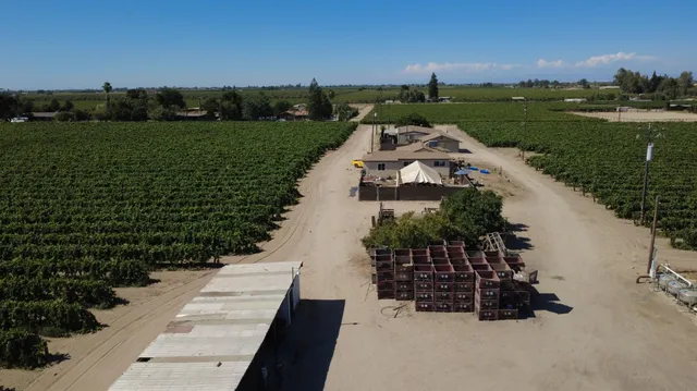 an aerial view of a house with a yard basket ball court and outdoor seating