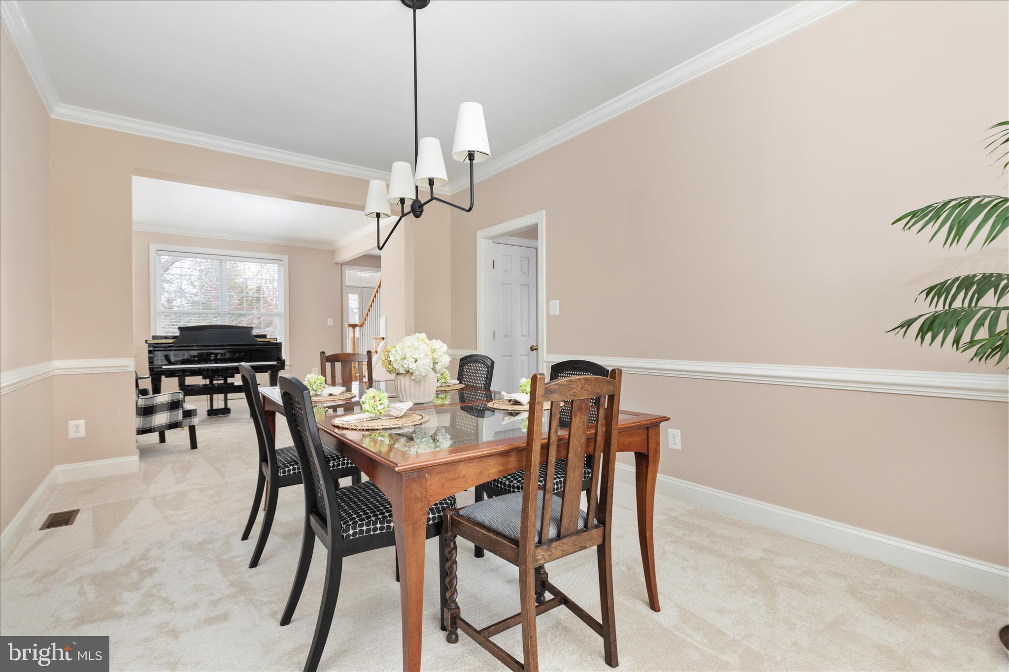10116 Middlebrooks Terrace Nokesville, VA 20181 - Photo 12 of 78 a view of a dining room with furniture and a chandelier