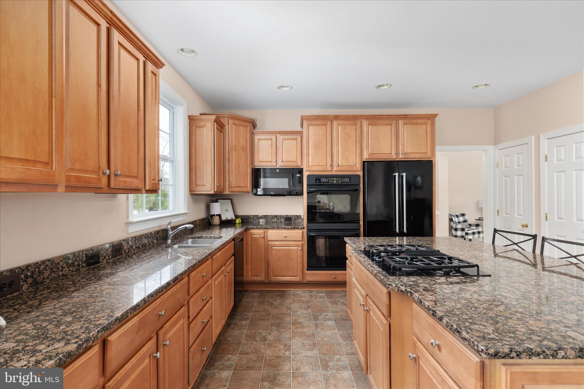 10116 Middlebrooks Terrace Nokesville, VA 20181 - Photo 14 of 78 a kitchen with stainless steel appliances granite countertop a stove refrigerator sink and cabinets