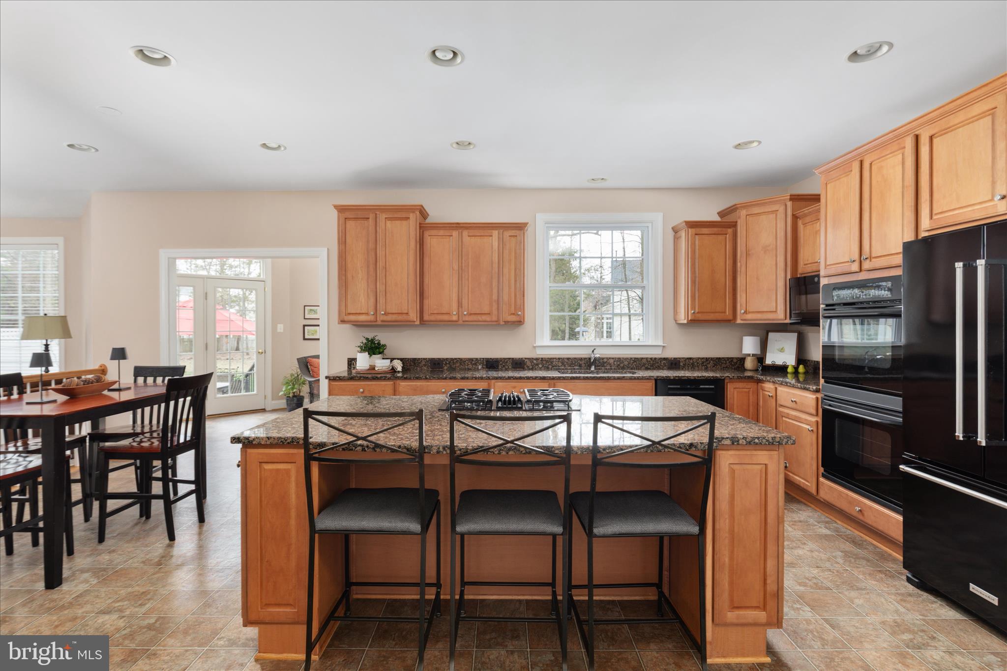 10116 Middlebrooks Terrace Nokesville, VA 20181 - Photo 16 of 78 a kitchen with a table chairs microwave and refrigerator