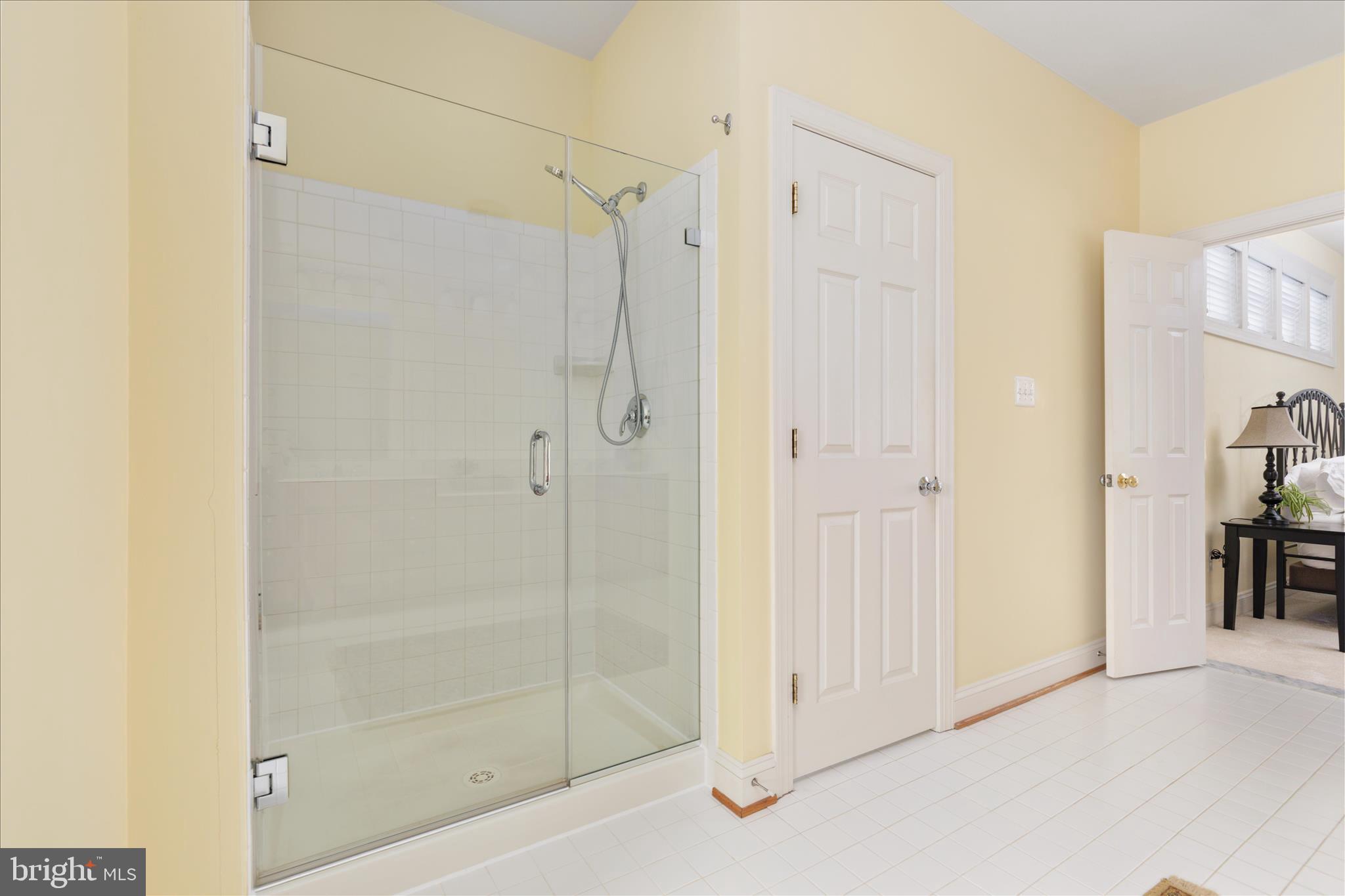 10116 Middlebrooks Terrace Nokesville, VA 20181 - Photo 42 of 78 a bathroom with a shower and a glass door