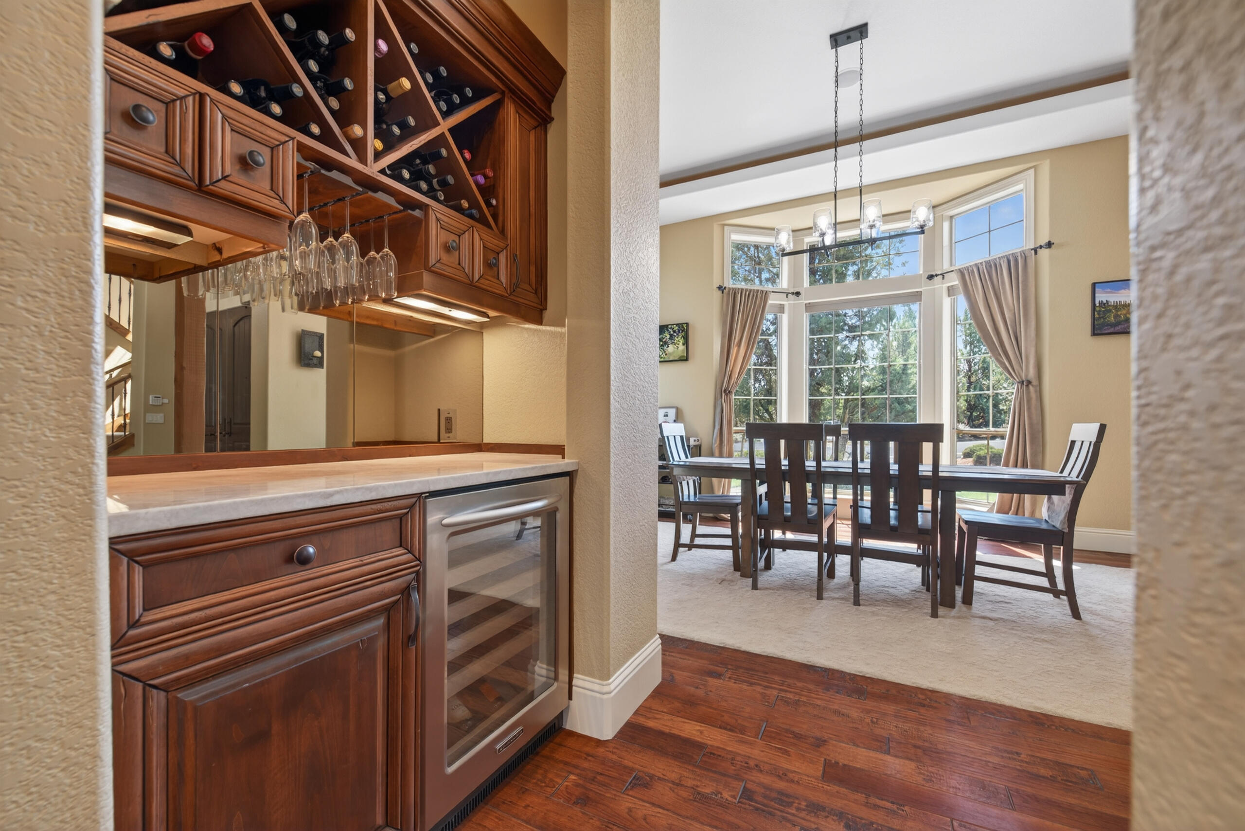 9009 Merlin Drive Redmond, OR 97756 - Photo 22 of 98 a view of a dining room with furniture window and wooden floor