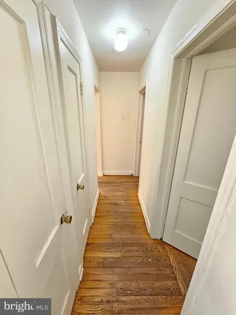 a view of hallway with wooden floor