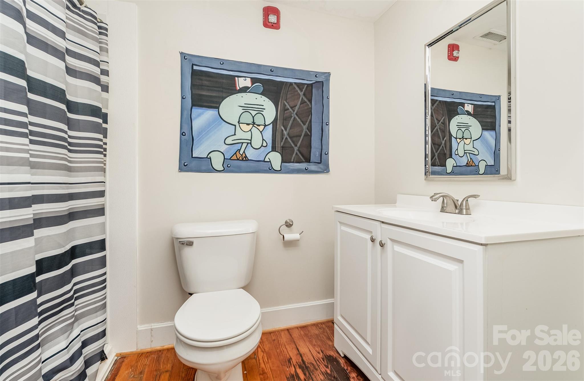 101 West Main Street Union, SC 29379 - Photo 13 of 29 a bathroom with a toilet a sink and mirror