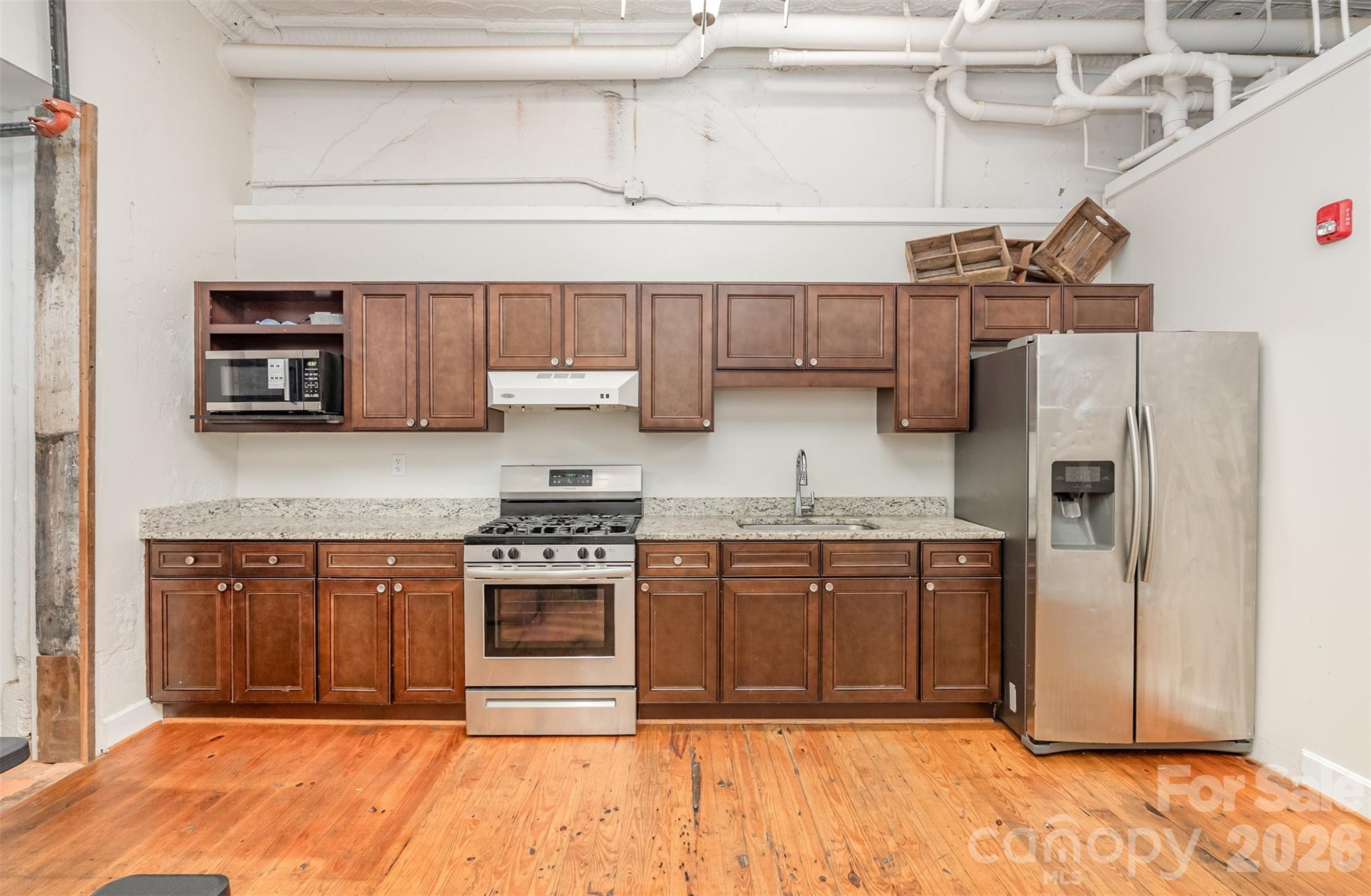 101 West Main Street Union, SC 29379 - Photo 6 of 29 a kitchen with stainless steel appliances granite countertop a stove top oven a sink and a refrigerator