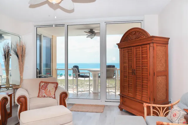 a living room with furniture ceiling fan and a flat screen tv