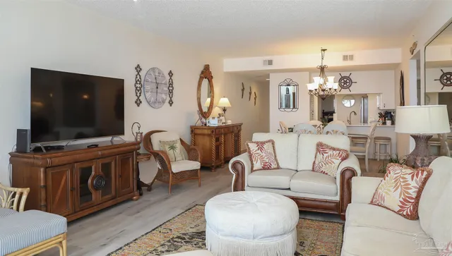 a view of a dining room with furniture and chandelier