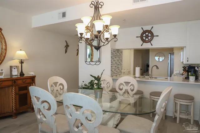 a view of a dining room with furniture wooden floor and chandelier