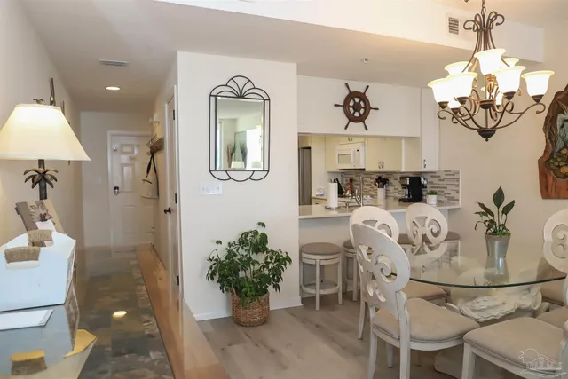 a kitchen with white cabinets and sink