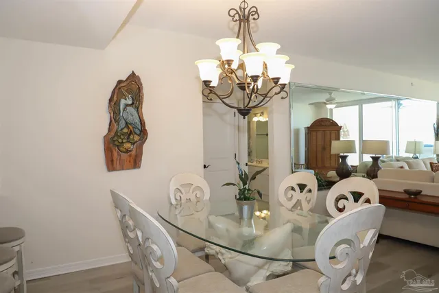 a bedroom with two beds and a chandelier