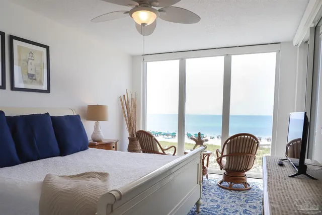 a bedroom with a bed wooden floor and a flat tv screen