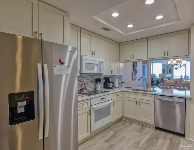 a bedroom with a bed and large windows