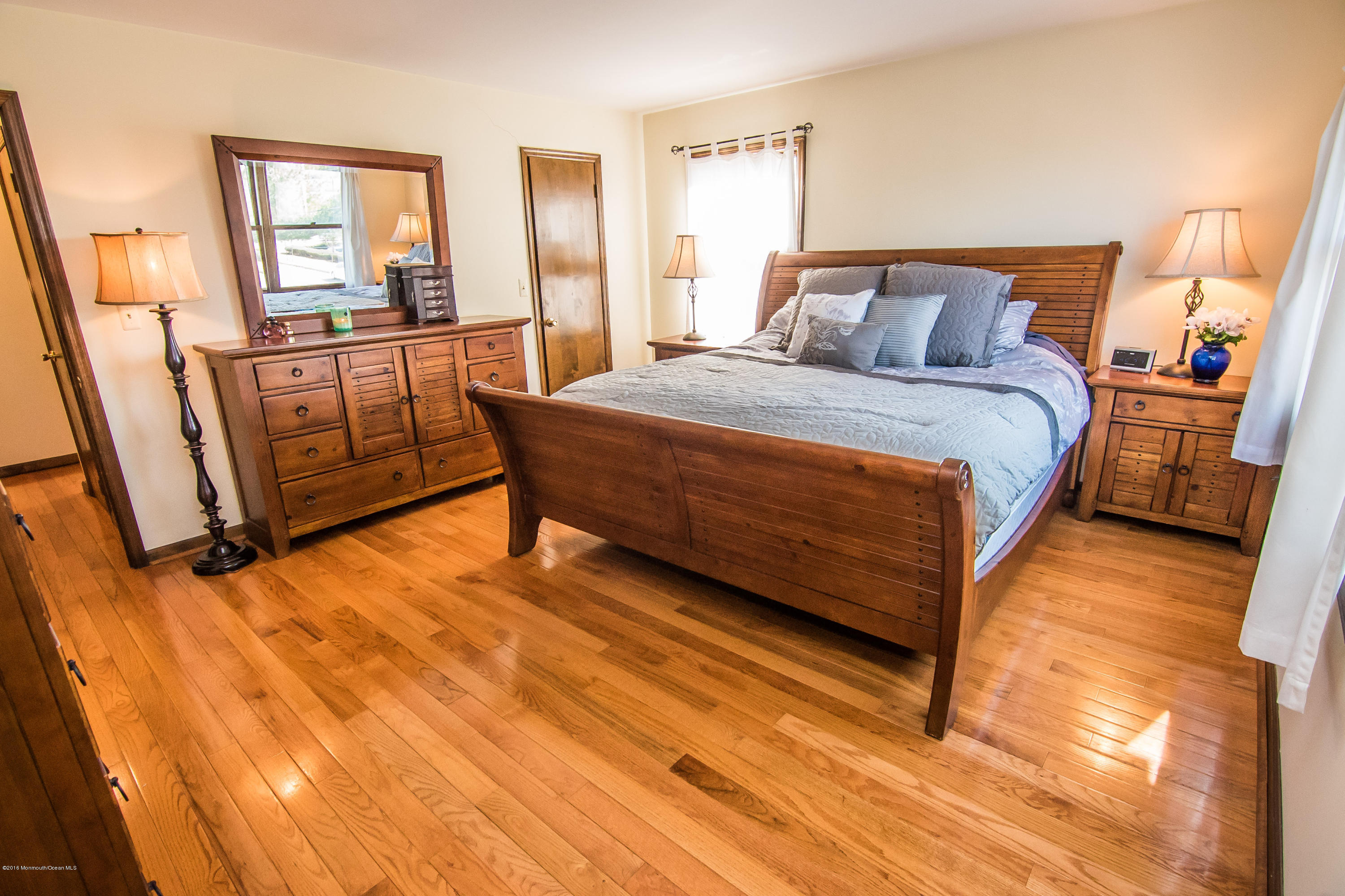 20 Pinckney Road, Unit A1 Red Bank, NJ 07701 - Photo 14 of 25 a bed sitting in a bedroom next to a window