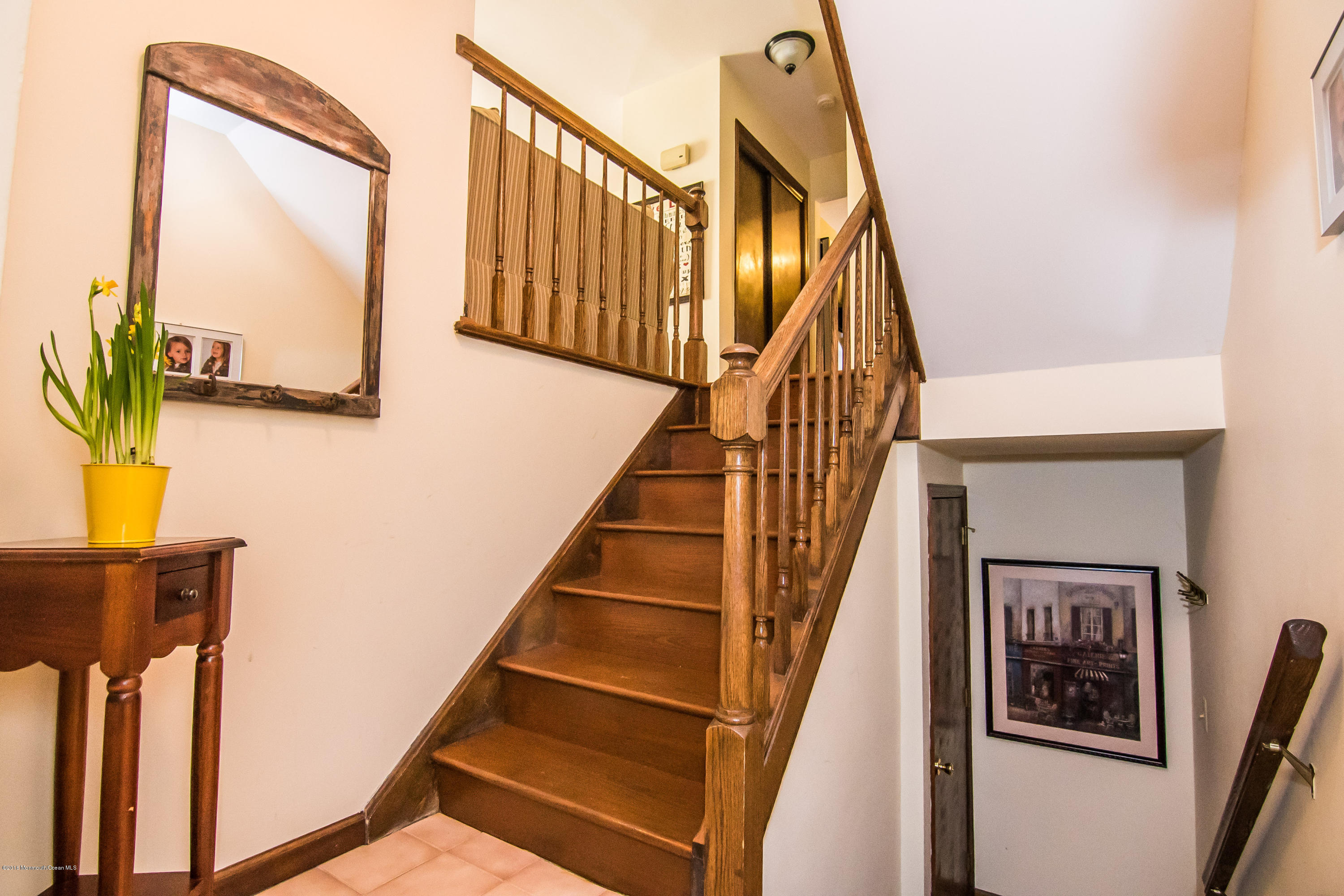 20 Pinckney Road, Unit A1 Red Bank, NJ 07701 - Photo 2 of 25 a view of staircase with wooden floor and a potted plant