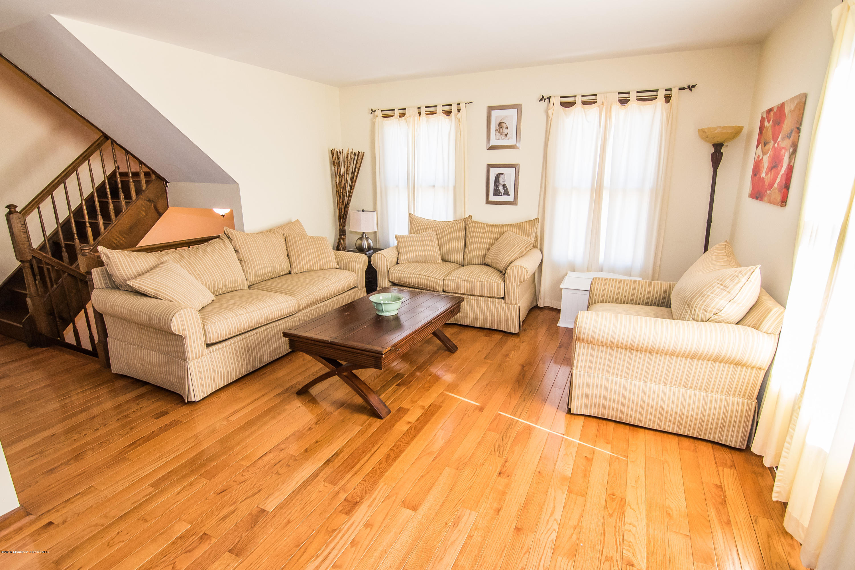 20 Pinckney Road, Unit A1 Red Bank, NJ 07701 - Photo 3 of 25 a living room with furniture and a rug