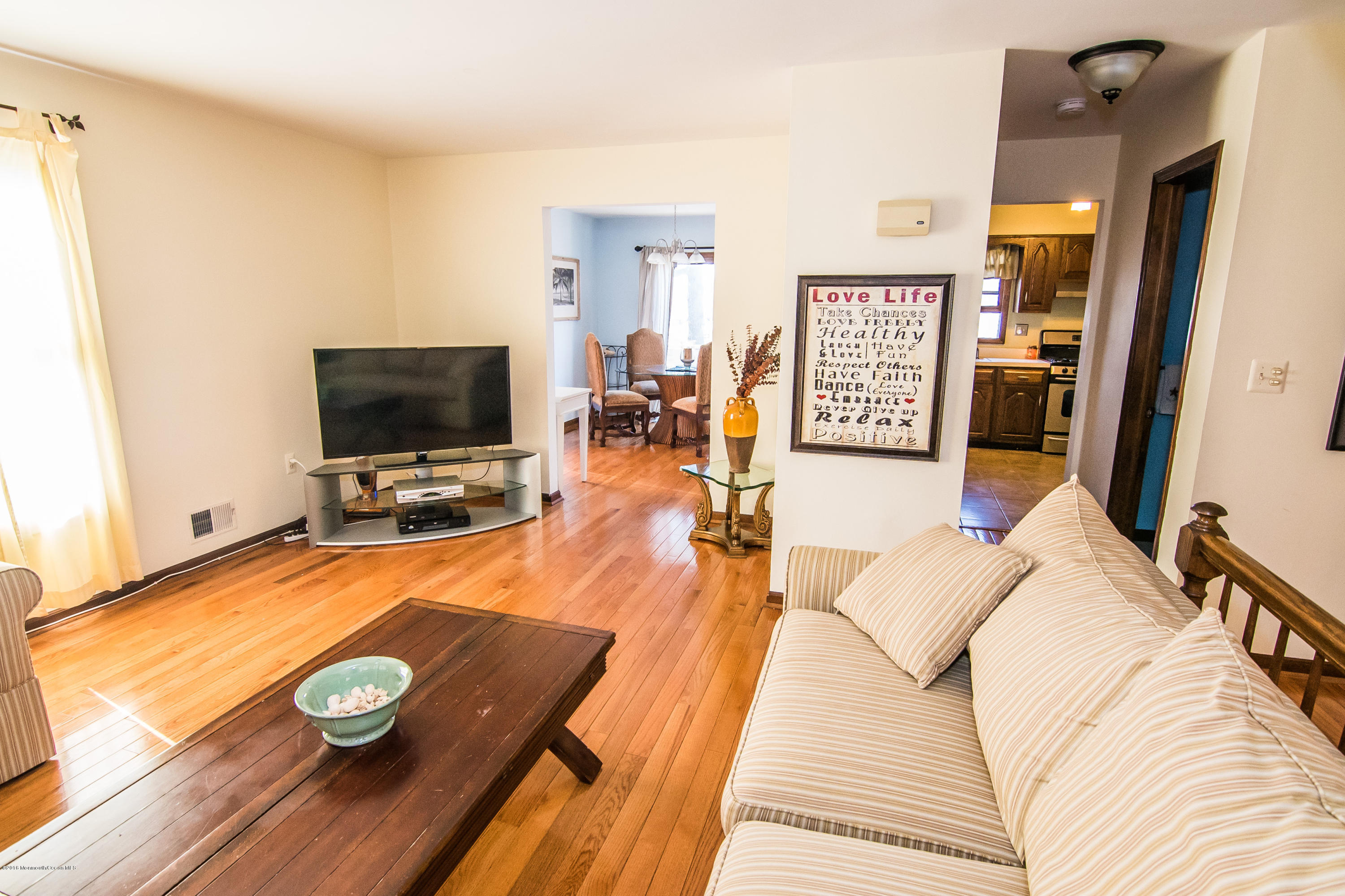 20 Pinckney Road, Unit A1 Red Bank, NJ 07701 - Photo 4 of 25 a living room with furniture and a flat screen tv