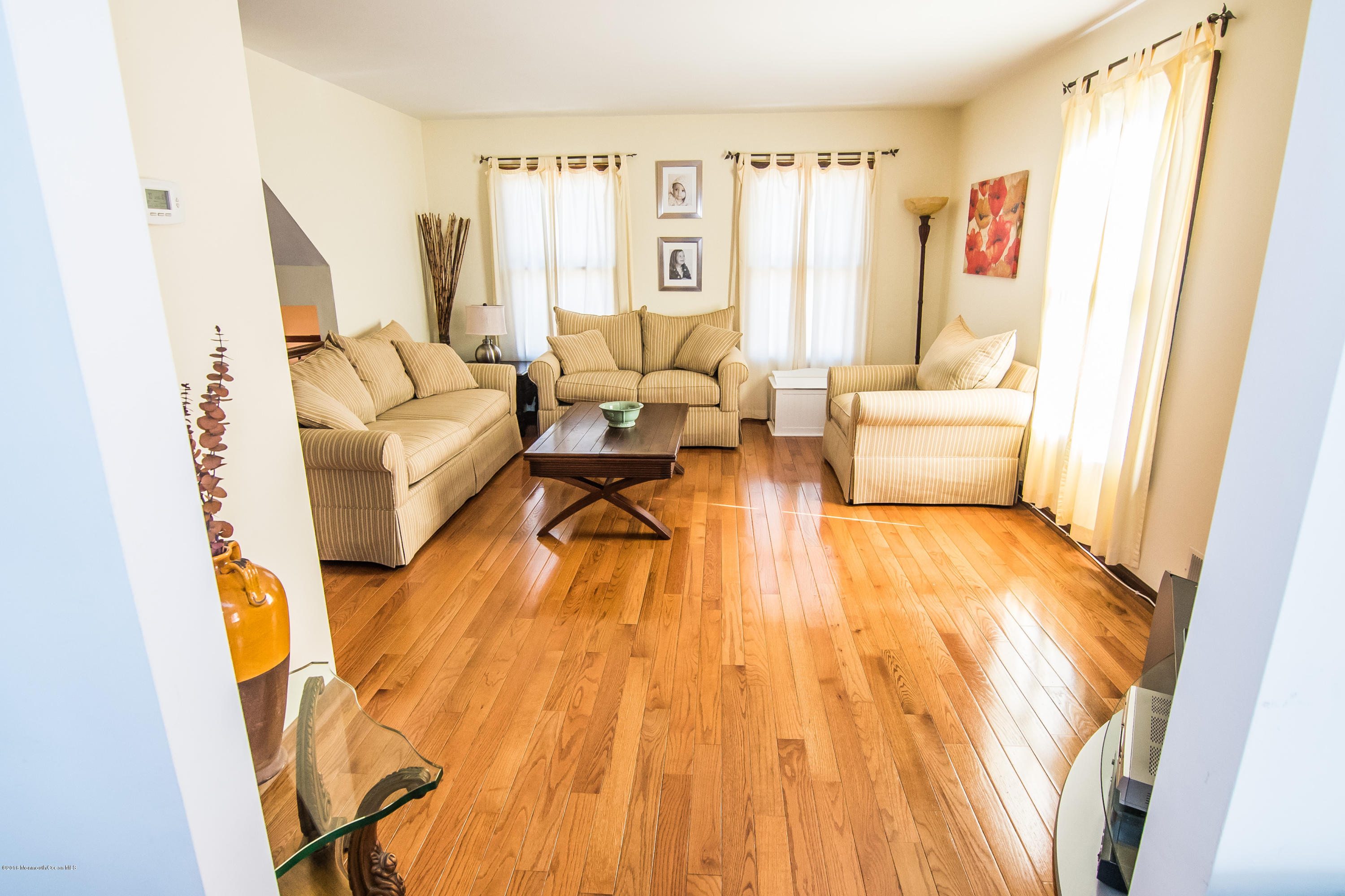 20 Pinckney Road, Unit A1 Red Bank, NJ 07701 - Photo 9 of 25 a living room with furniture and a wooden floor