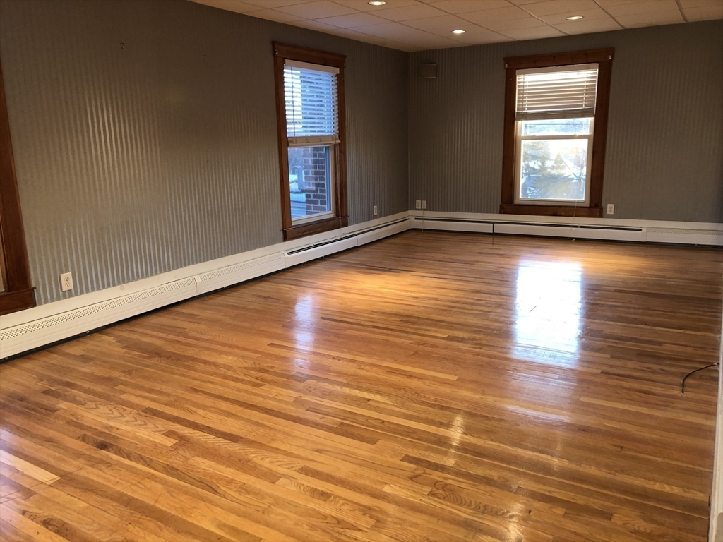 184 Middle Street, Unit 2 Braintree, MA 02184 - Photo 7 of 14 wooden floor in an empty room with a window