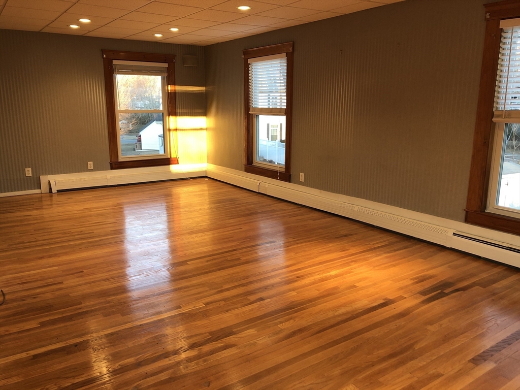 184 Middle Street, Unit 2 Braintree, MA 02184 - Photo 8 of 14 an empty room with wooden floor and windows