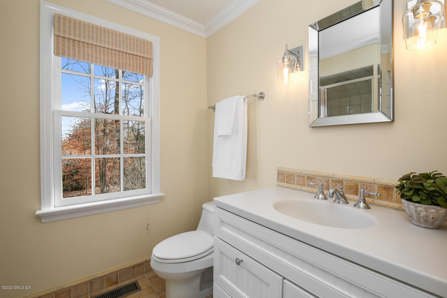 22 Normandy Lane Riverside, CT 06878 - Photo 27 of 34 a bathroom with a sink a toilet and a mirror