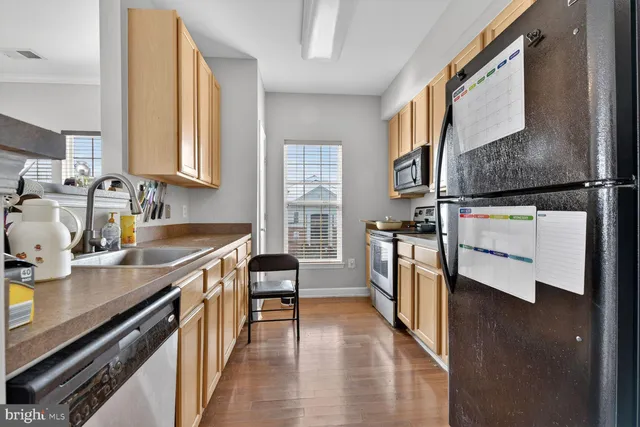 a kitchen with stainless steel appliances a sink and a stove