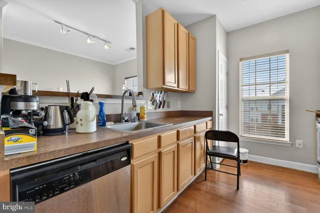 a kitchen with sink and cabinets
