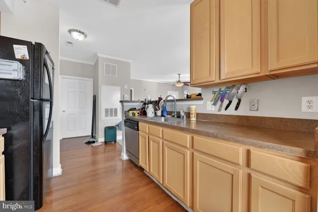 a kitchen with sink cabinets and stainless steel appliances