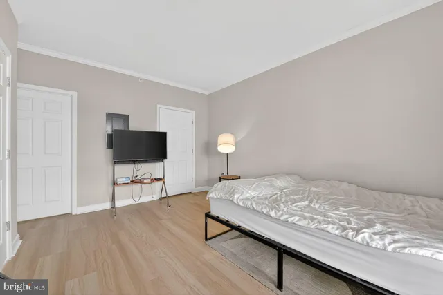 a bedroom with a bed and a flat screen tv