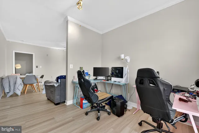 a view of a workspace with furniture and wooden floor