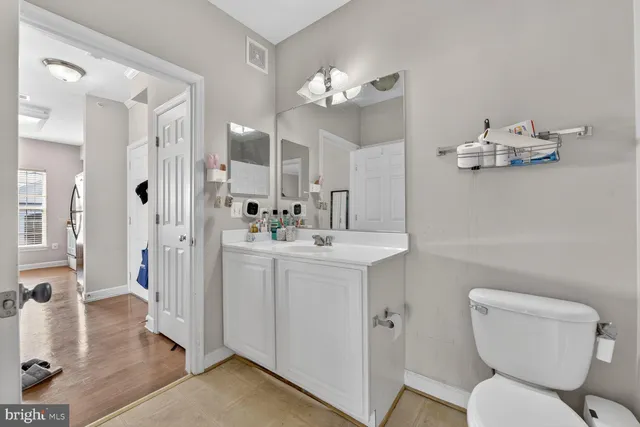 a bathroom with a toilet a sink and mirror