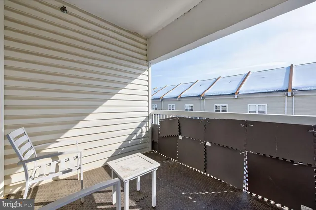 a view of a patio with table and chairs with wooden floor