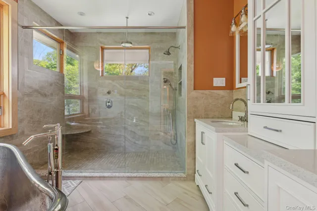 a bathroom with a shower and a sink