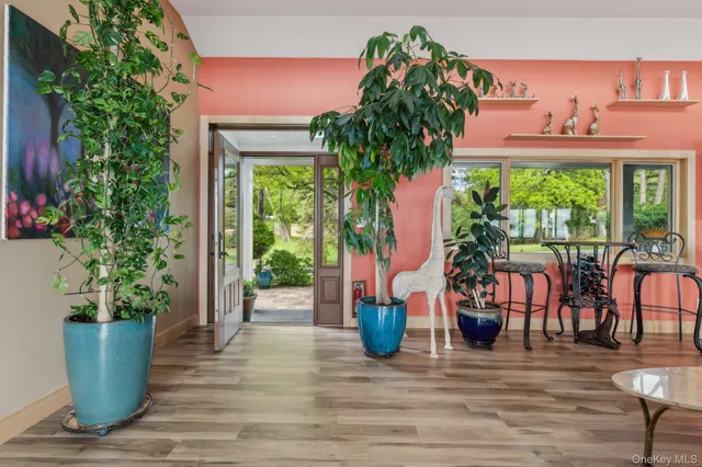 a view of a house with potted plants and more windows