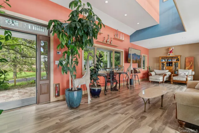 a room with lots of furniture and potted plants