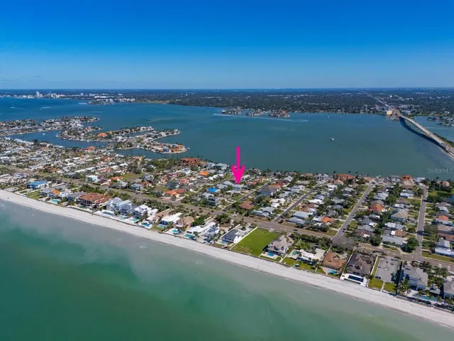 an aerial view of a residential houses with city view